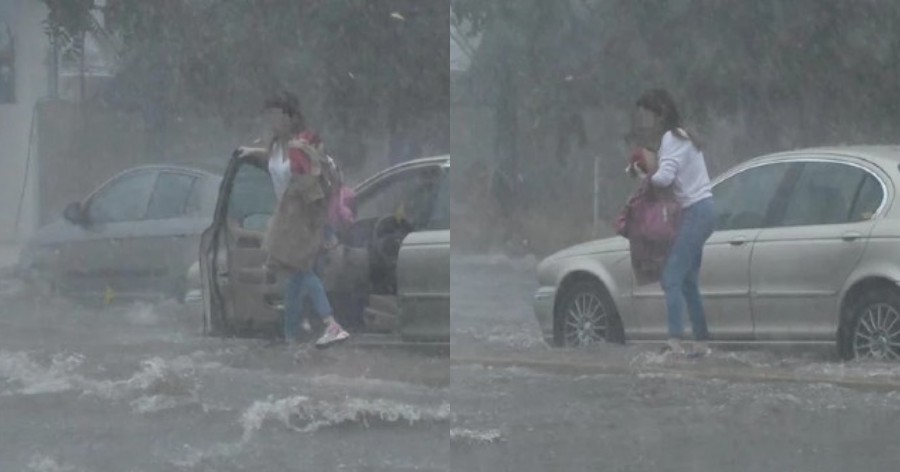 Έντρομη γυναίκα εγκαταλείπει το αυτοκίνητο στη μέση του δρόμου στην πλημμυρισμένη Πειραιώς