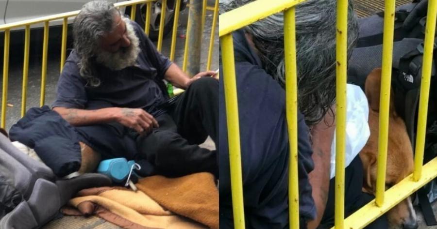 Άστεγος άνδρας μας «έβαλε» τα γυαλιά: Έβγαλε το μπουφάν του στη βροχή, για να σκεπάσει τον σκύλο του