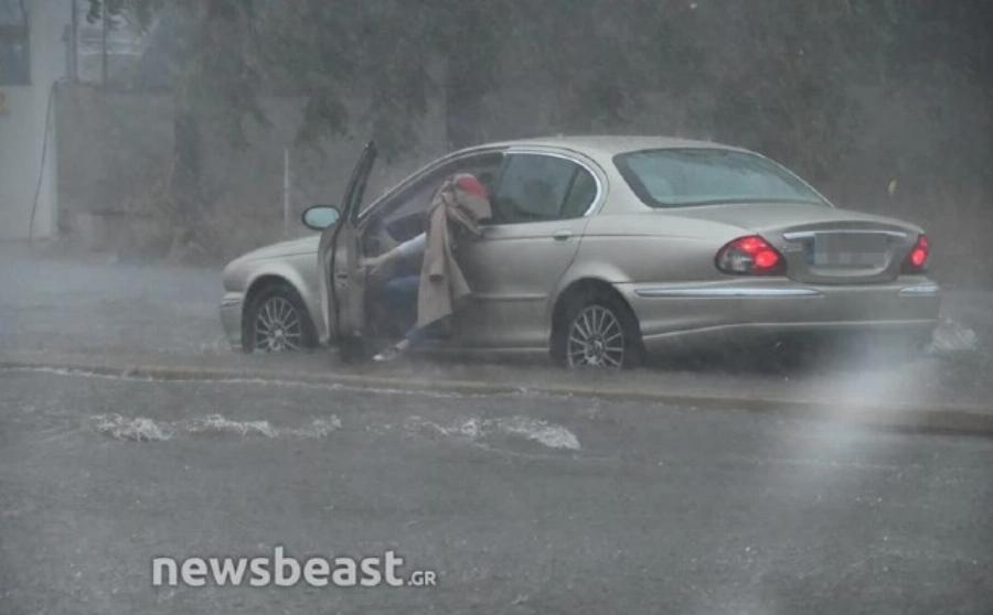 Έντρομη γυναίκα εγκαταλείπει το αυτοκίνητο στη μέση του δρόμου στην πλημμυρισμένη Πειραιώς